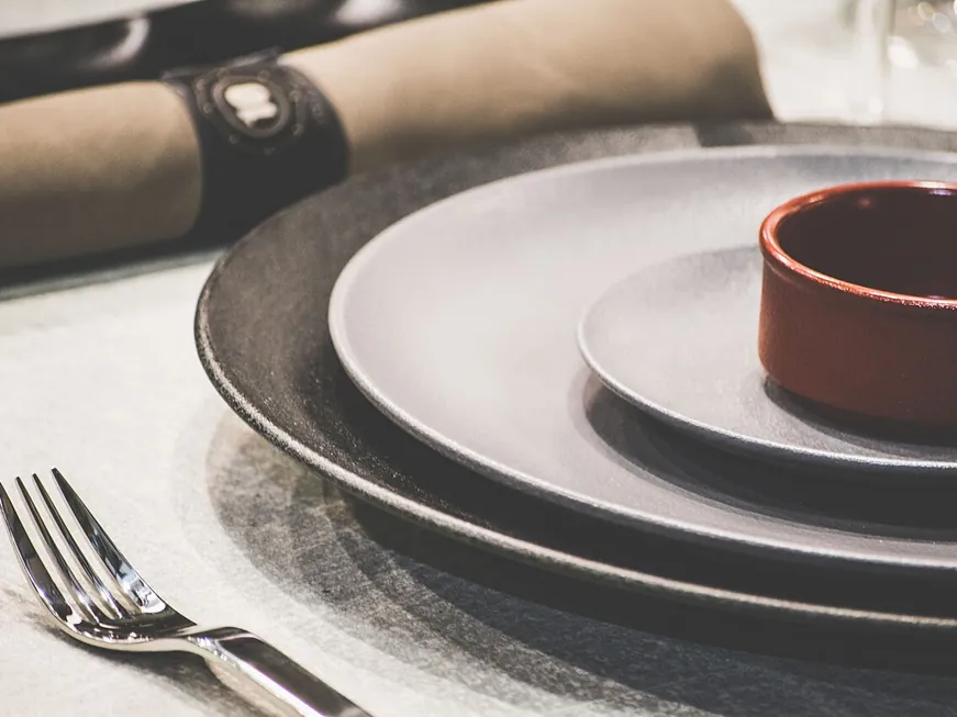 Stoneware plates and a small terracotta bowl on a table