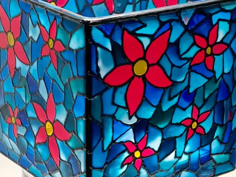 Hand-painted mosaic glass candle holder with red flowers on blue, from Votive Vault